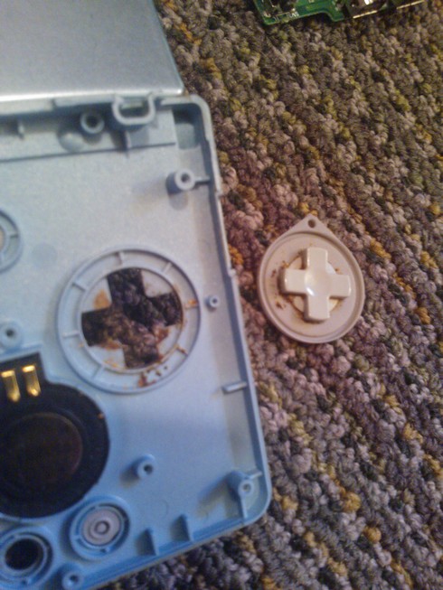 A very dirty directional pad and its silicon cover