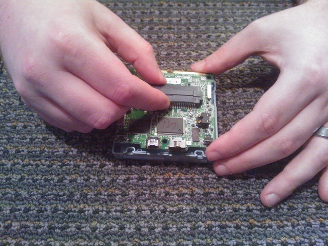 Holding the board by the cartridge port and the edge